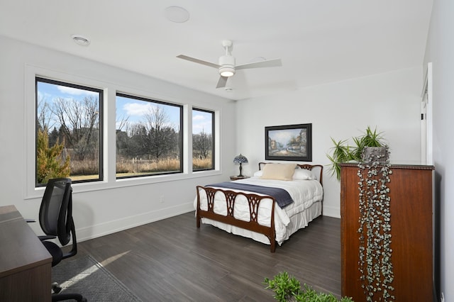 bedroom with baseboards, dark wood-style flooring, and ceiling fan