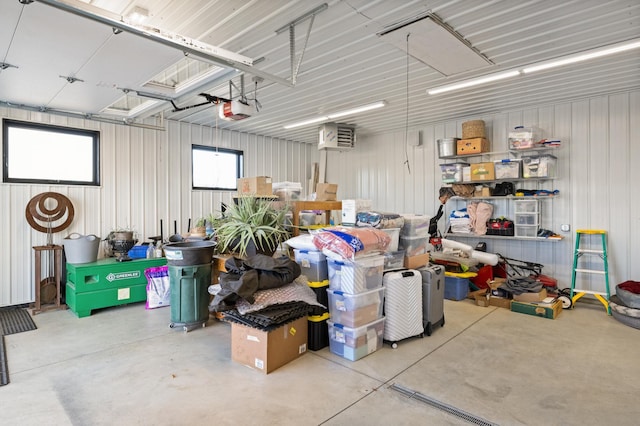 garage with a garage door opener and metal wall