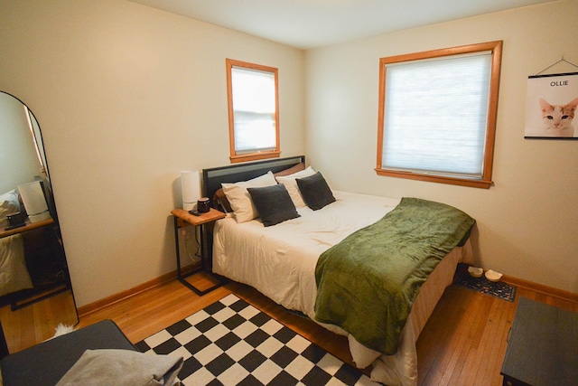 bedroom featuring light wood-style flooring and baseboards