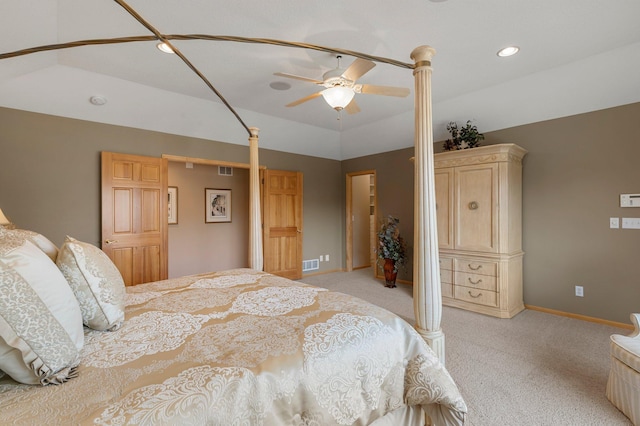 bedroom with baseboards, visible vents, lofted ceiling, and light carpet