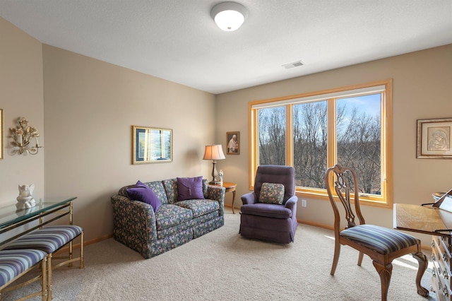 carpeted living room featuring visible vents and baseboards