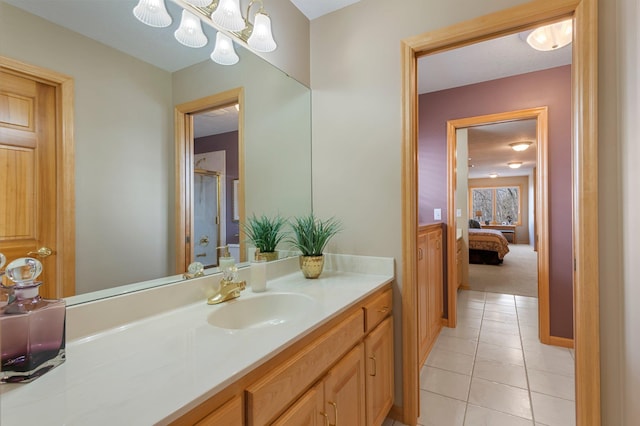 full bath featuring vanity, tile patterned floors, and a shower with shower door