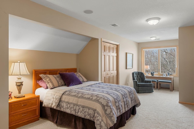 bedroom featuring baseboards, visible vents, carpet floors, and lofted ceiling