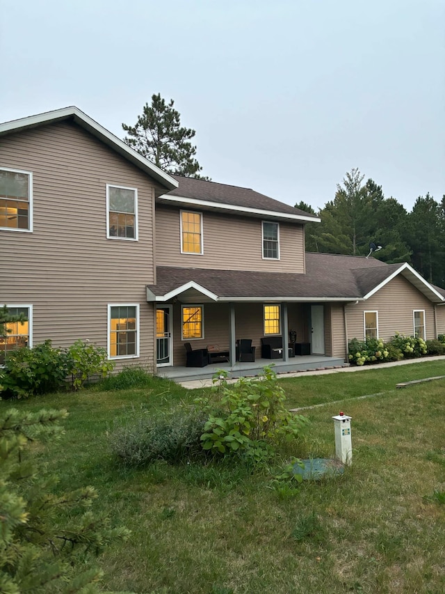 back of property featuring a lawn and a patio area