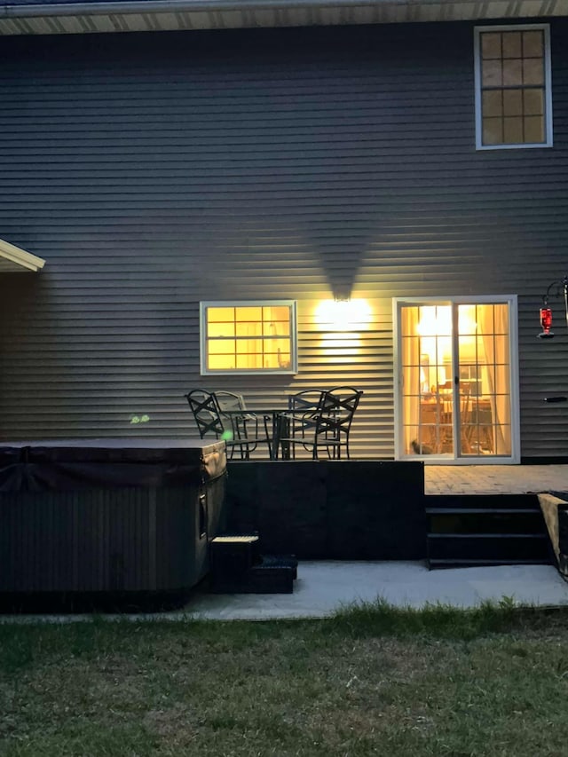 rear view of house with a hot tub