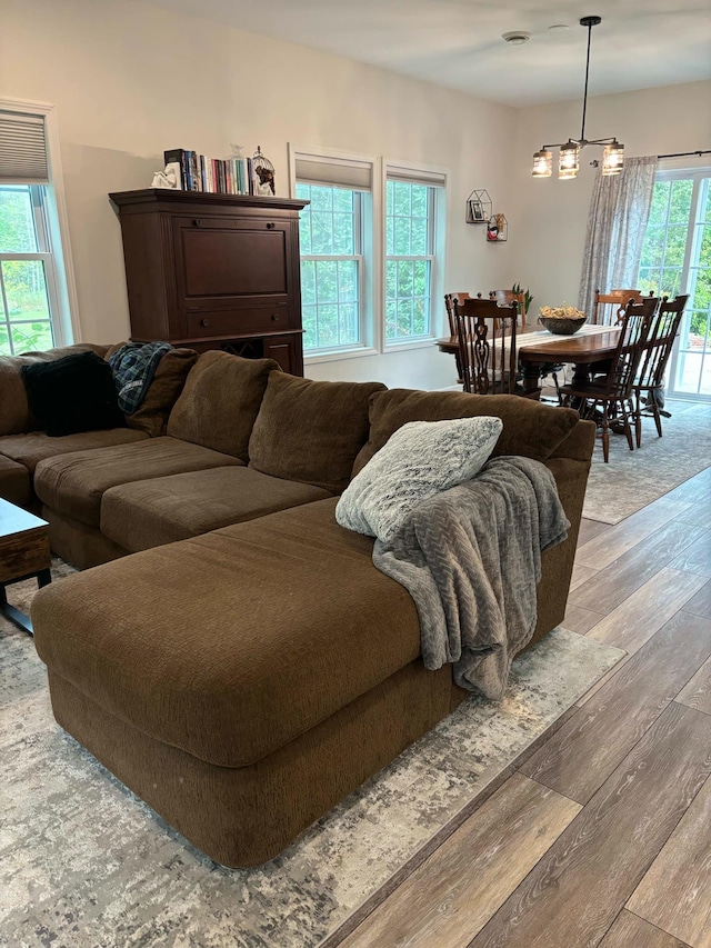 living room with wood finished floors and a chandelier