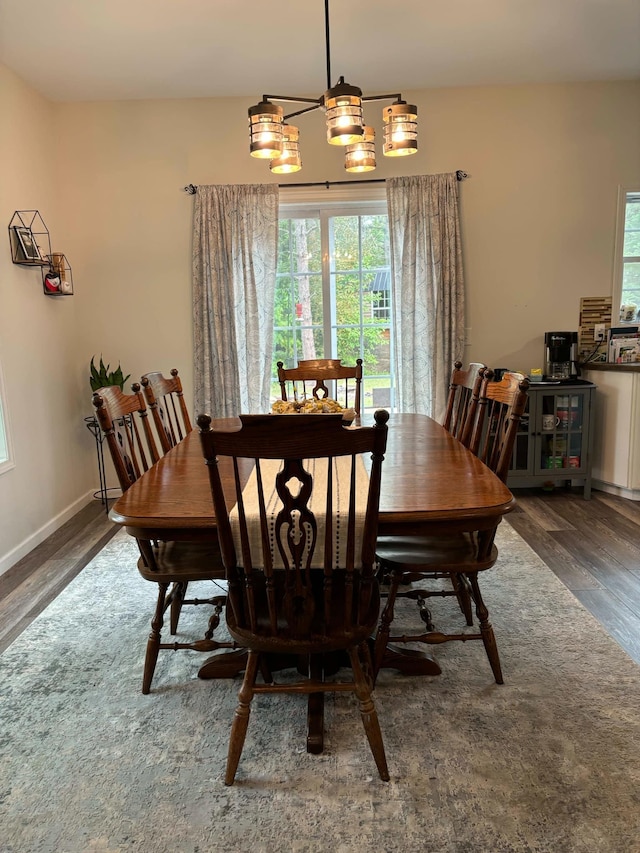 dining area with baseboards and wood finished floors