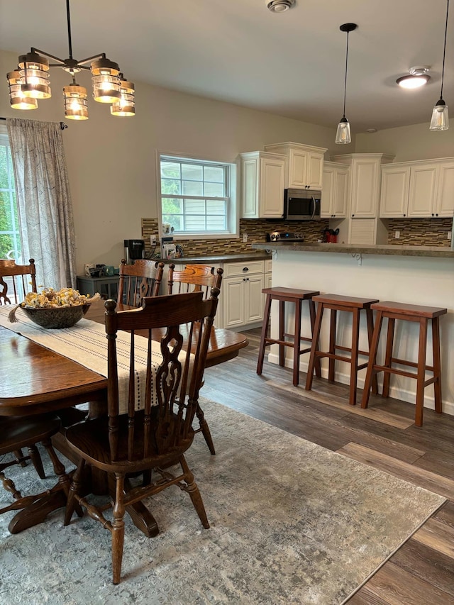 dining area with visible vents and dark wood finished floors