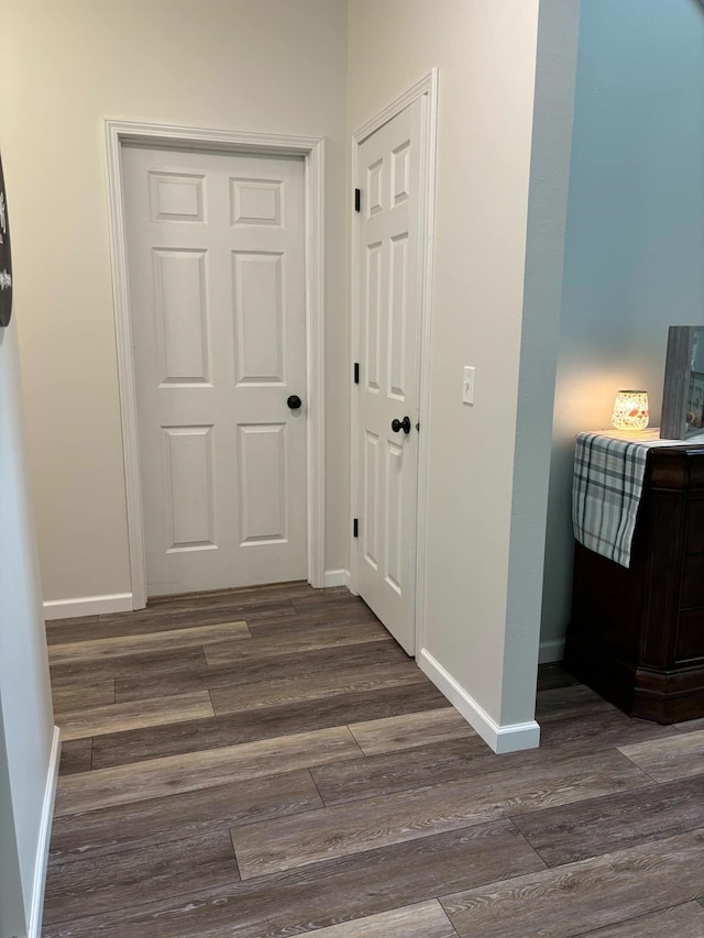 hallway with baseboards and dark wood finished floors