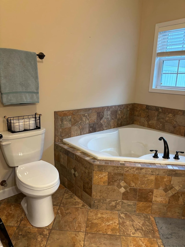 bathroom featuring a bath and toilet