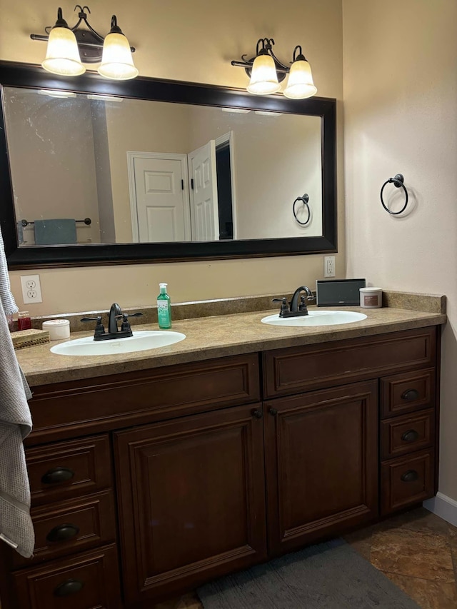 full bathroom featuring a sink and double vanity