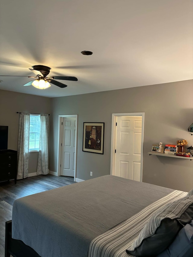 bedroom with wood finished floors, baseboards, and ceiling fan