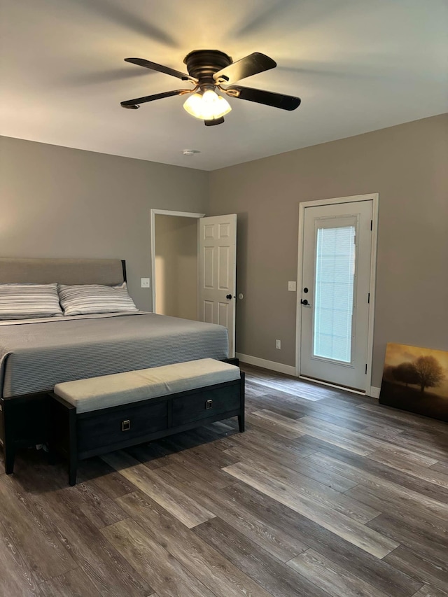 bedroom featuring baseboards, ceiling fan, and dark wood-style flooring