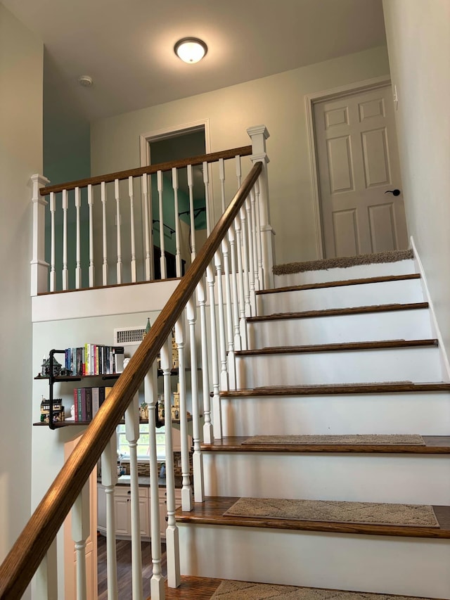 stairway featuring wood finished floors