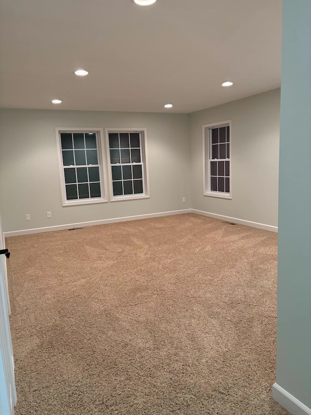 carpeted spare room featuring recessed lighting and baseboards