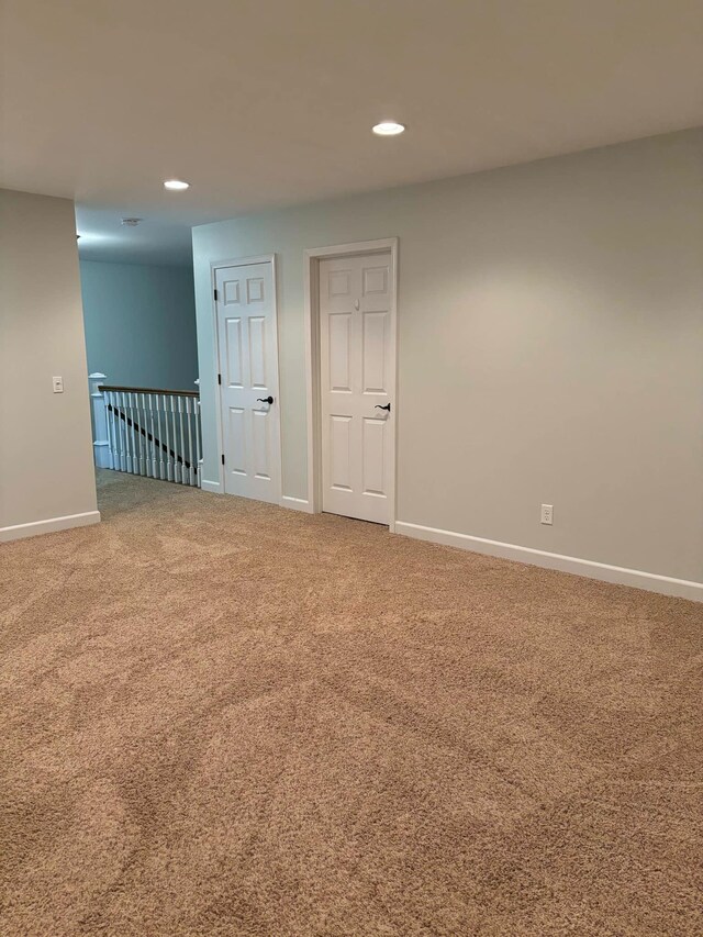 carpeted spare room featuring recessed lighting and baseboards