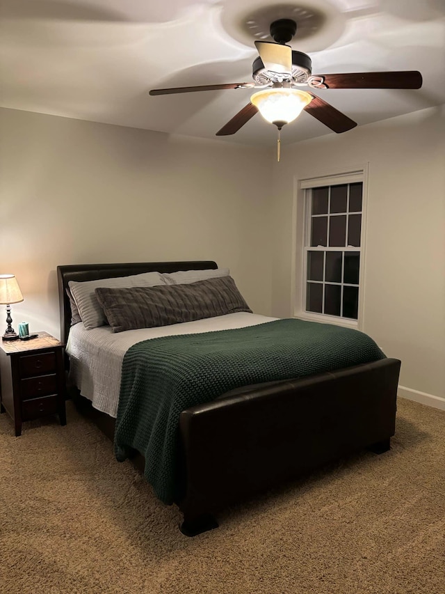 bedroom featuring ceiling fan, baseboards, and carpet