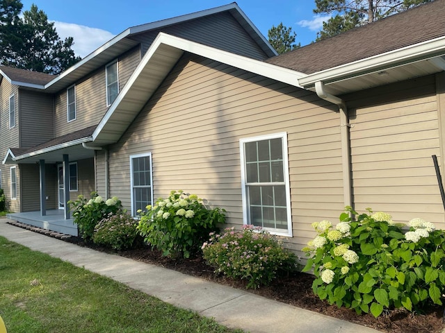 view of side of property with covered porch