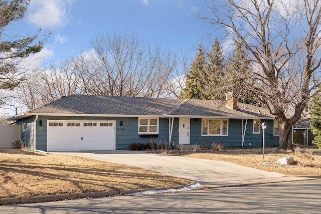 ranch-style home with fence, driveway, an attached garage, a shingled roof, and a chimney