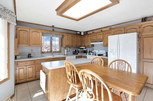 kitchen featuring visible vents, a sink, white appliances, light countertops, and light tile patterned floors