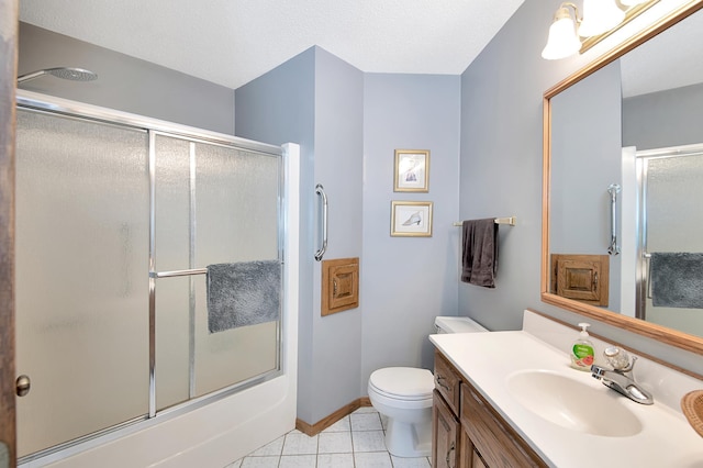 full bath featuring tile patterned flooring, baseboards, toilet, enclosed tub / shower combo, and vanity