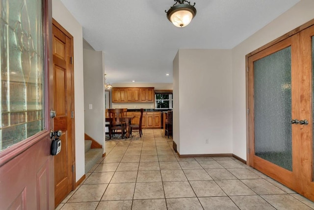 foyer entrance with light tile patterned floors, recessed lighting, stairs, and baseboards