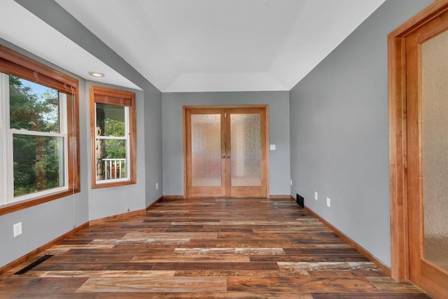 interior space featuring visible vents, baseboards, french doors, wood finished floors, and a raised ceiling