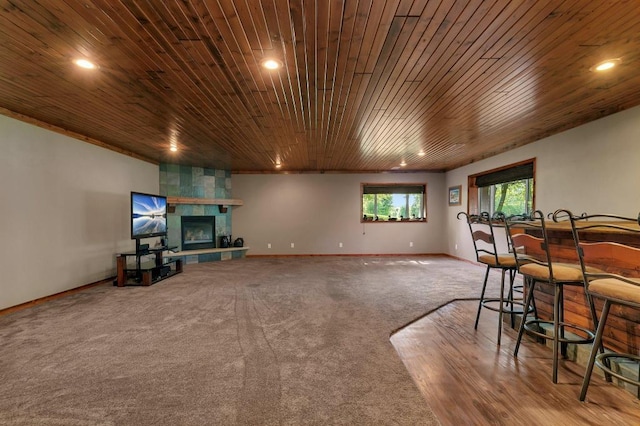 living area featuring wood ceiling, recessed lighting, a fireplace, and baseboards