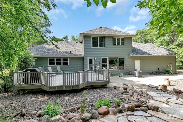 back of property featuring central air condition unit, a deck, and a patio area