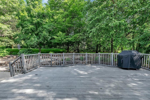 wooden deck with a grill