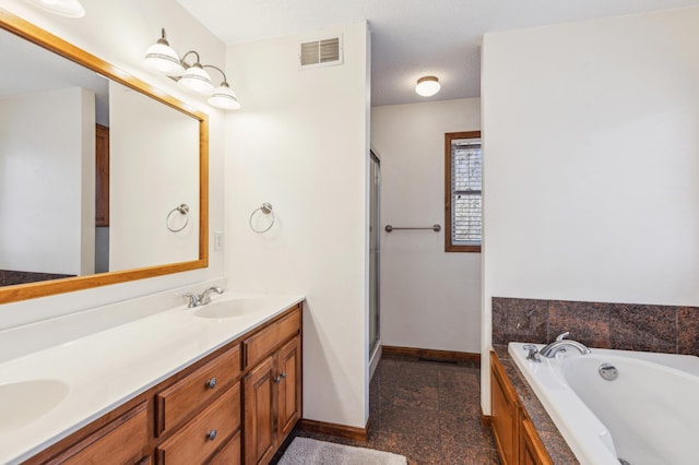 bathroom featuring visible vents, baseboards, double vanity, granite finish floor, and a sink