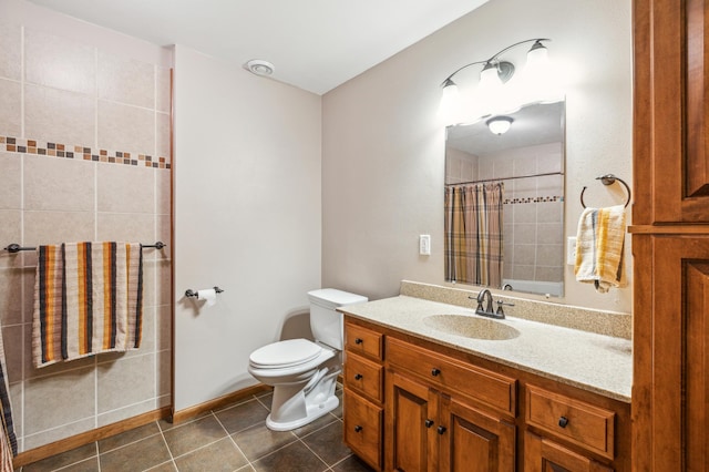 full bath with tile patterned flooring, toilet, vanity, and a tile shower