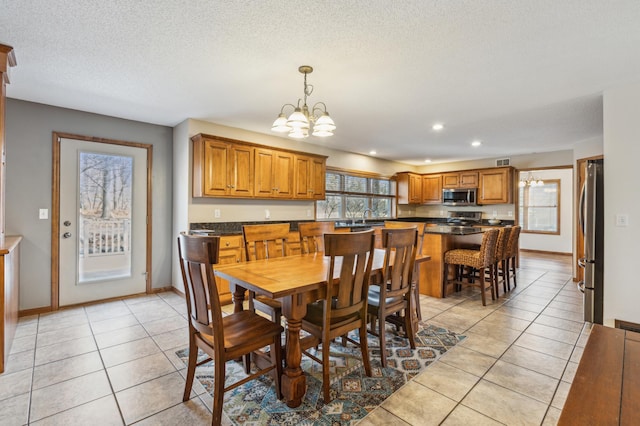 dining room featuring baseboards, recessed lighting, an inviting chandelier, light tile patterned flooring, and a textured ceiling