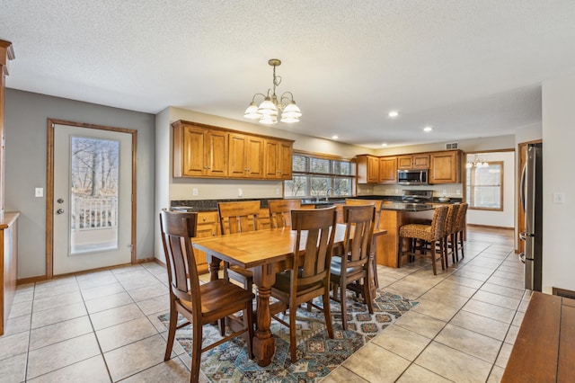 5492 Garden Hills Dr, Saint Augusta, MN 56301 - dining room with light tile patterned floors, baseboards, recessed lighting, a textured ceiling, and a notable chandelier