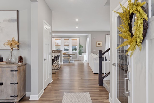 foyer entrance with recessed lighting, stairs, baseboards, and wood finished floors