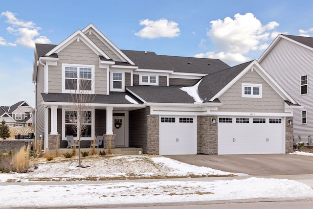 craftsman house with concrete driveway, roof with shingles, covered porch, a garage, and stone siding