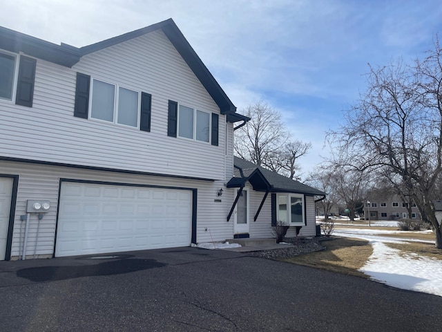 view of front of property with aphalt driveway and an attached garage