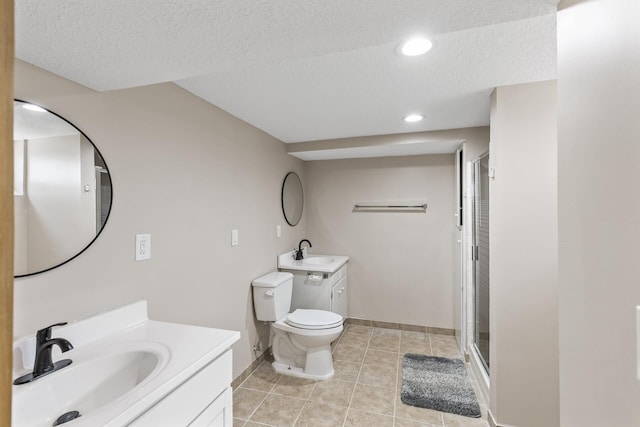 bathroom featuring tile patterned flooring, a shower stall, toilet, and a sink