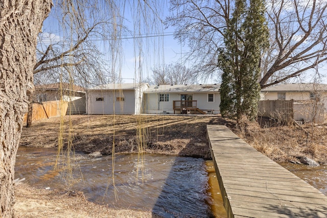 rear view of property featuring fence