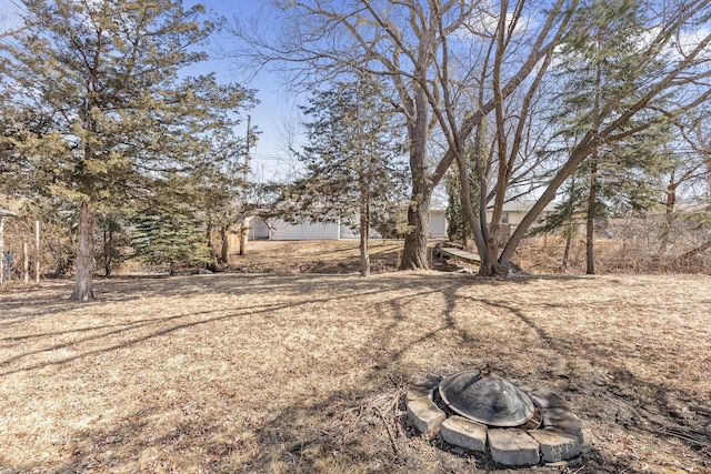 view of yard featuring an outdoor fire pit