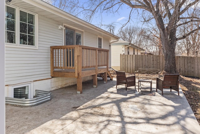 view of patio / terrace with a deck and fence