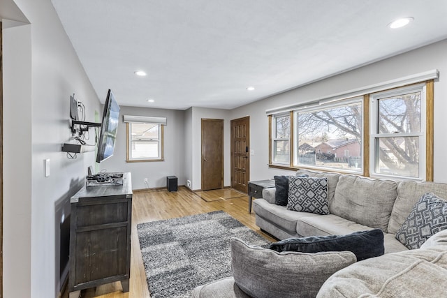 living area with recessed lighting, light wood-type flooring, and baseboards