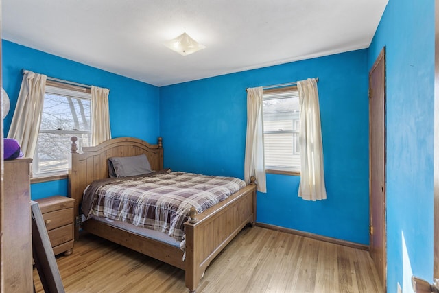 bedroom featuring baseboards and wood finished floors