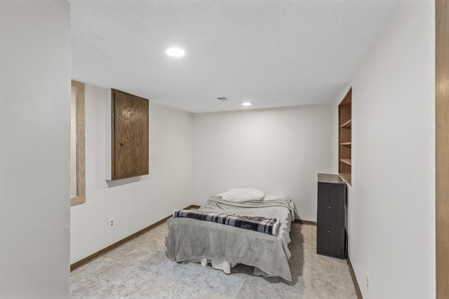 bedroom featuring recessed lighting, visible vents, baseboards, and a textured ceiling