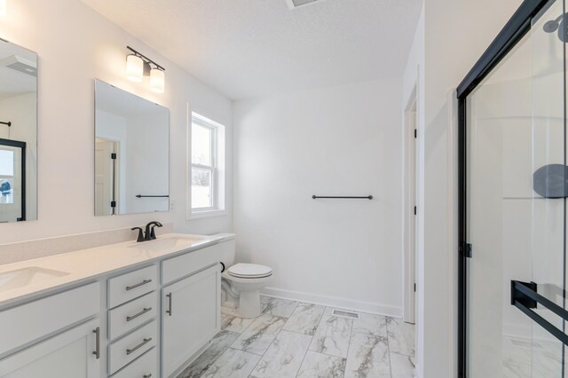 full bath featuring double vanity, a sink, toilet, marble finish floor, and a shower with door