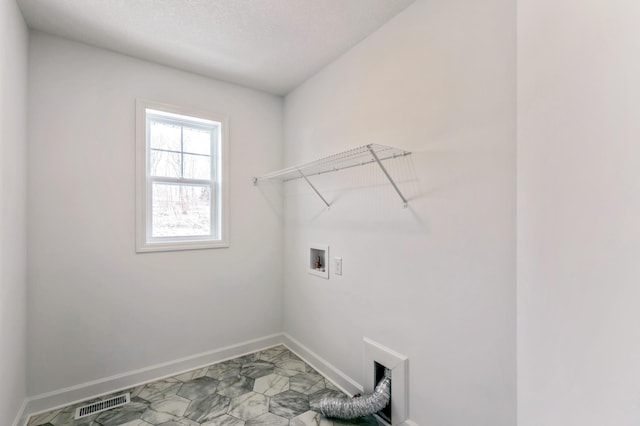 laundry room featuring visible vents, baseboards, washer hookup, laundry area, and a textured ceiling