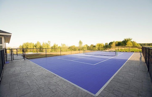 view of tennis court with fence