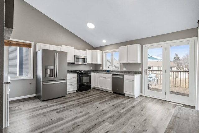 kitchen featuring a sink, white cabinets, light wood-type flooring, and stainless steel appliances