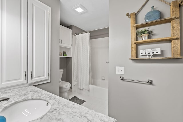 full bathroom with tile patterned flooring, vanity, toilet, and shower / bath combo with shower curtain