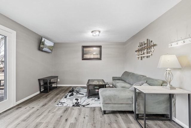 living room featuring baseboards and wood finished floors